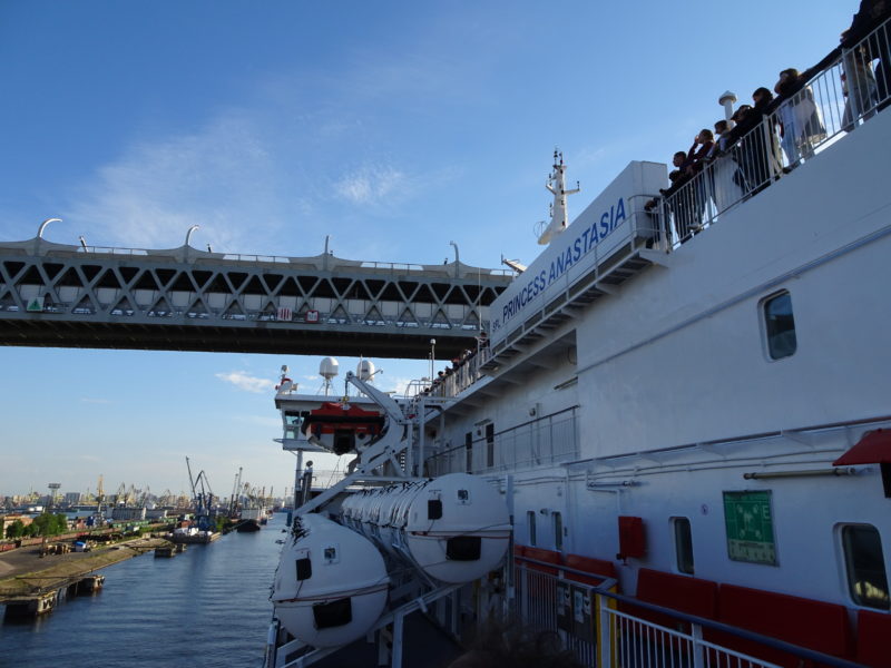 Ship sailing beneath bridge