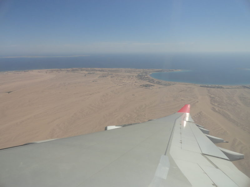 Aircraft wing and desert coastline