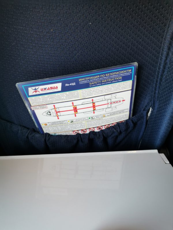 Aircraft tray table and safety instruction card