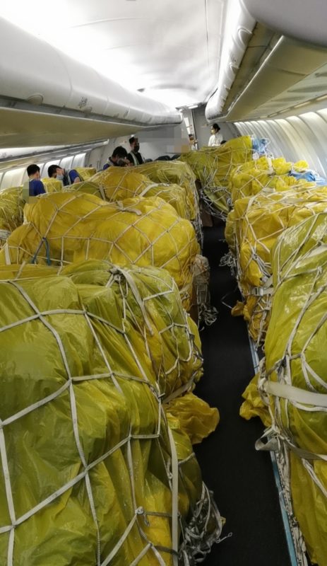 Yellow tarp covering cargo in aircraft
